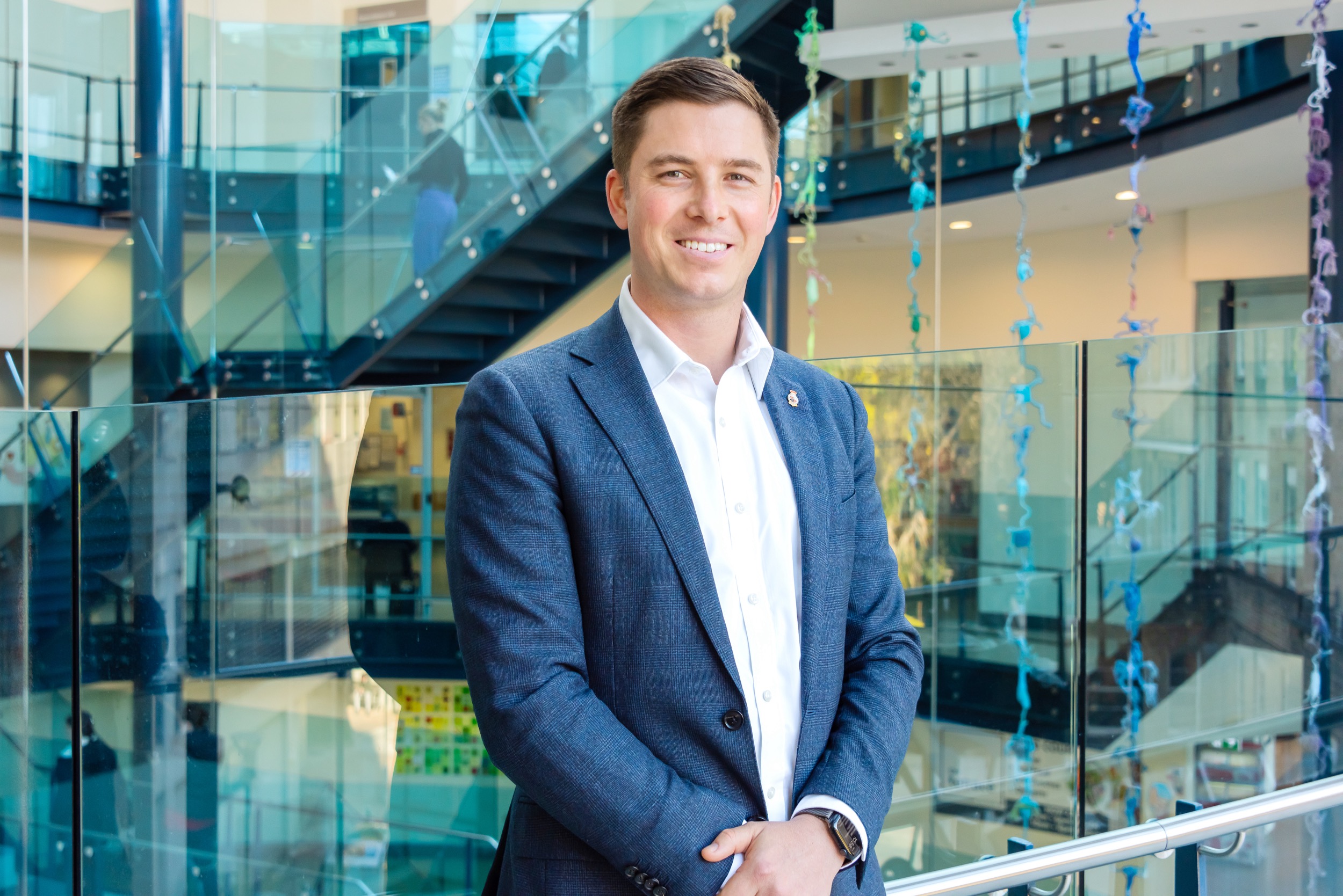 Kiel Harvey posing for a photo in the atrium of Royal Prince Alfred Hospital.