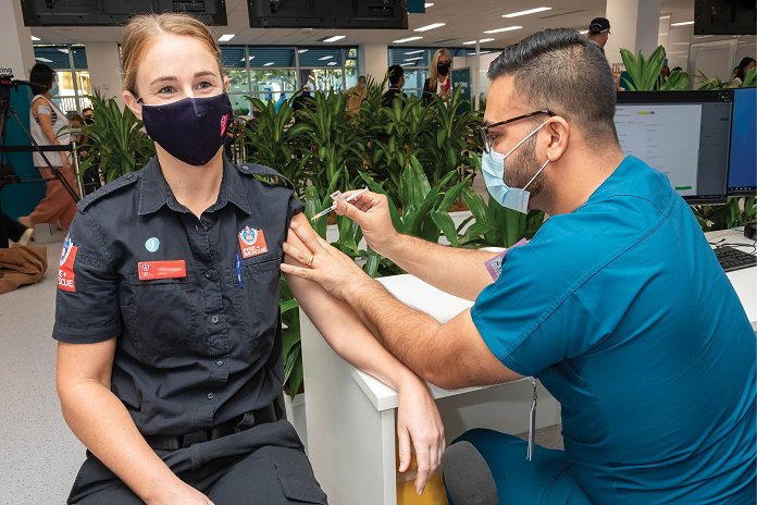 Woman in Ambulance uniform getting vaccination