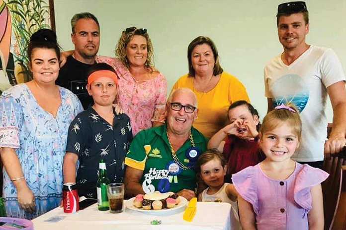 Group of people standing around a table