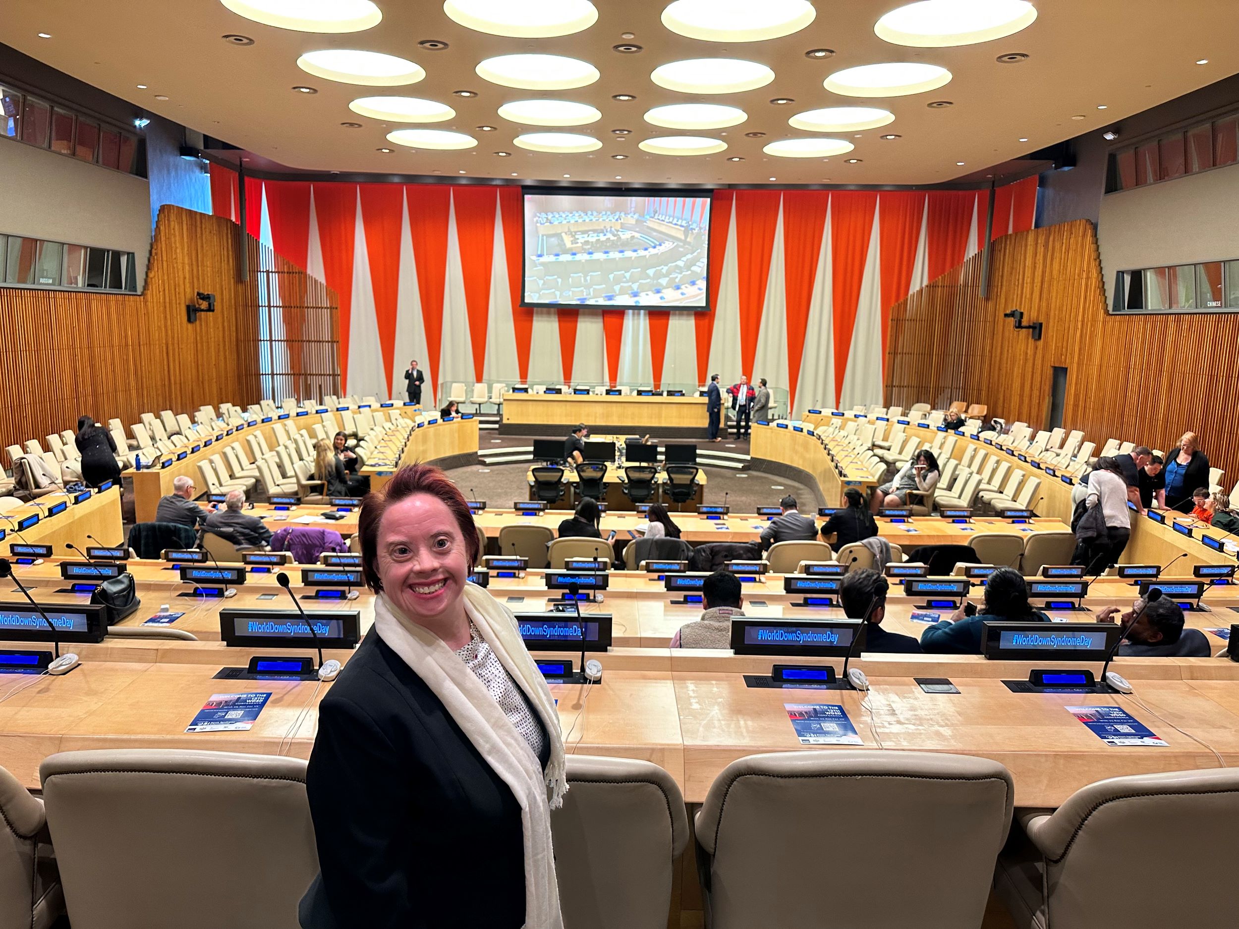 Woman standing in front of large auditorium facing the camera