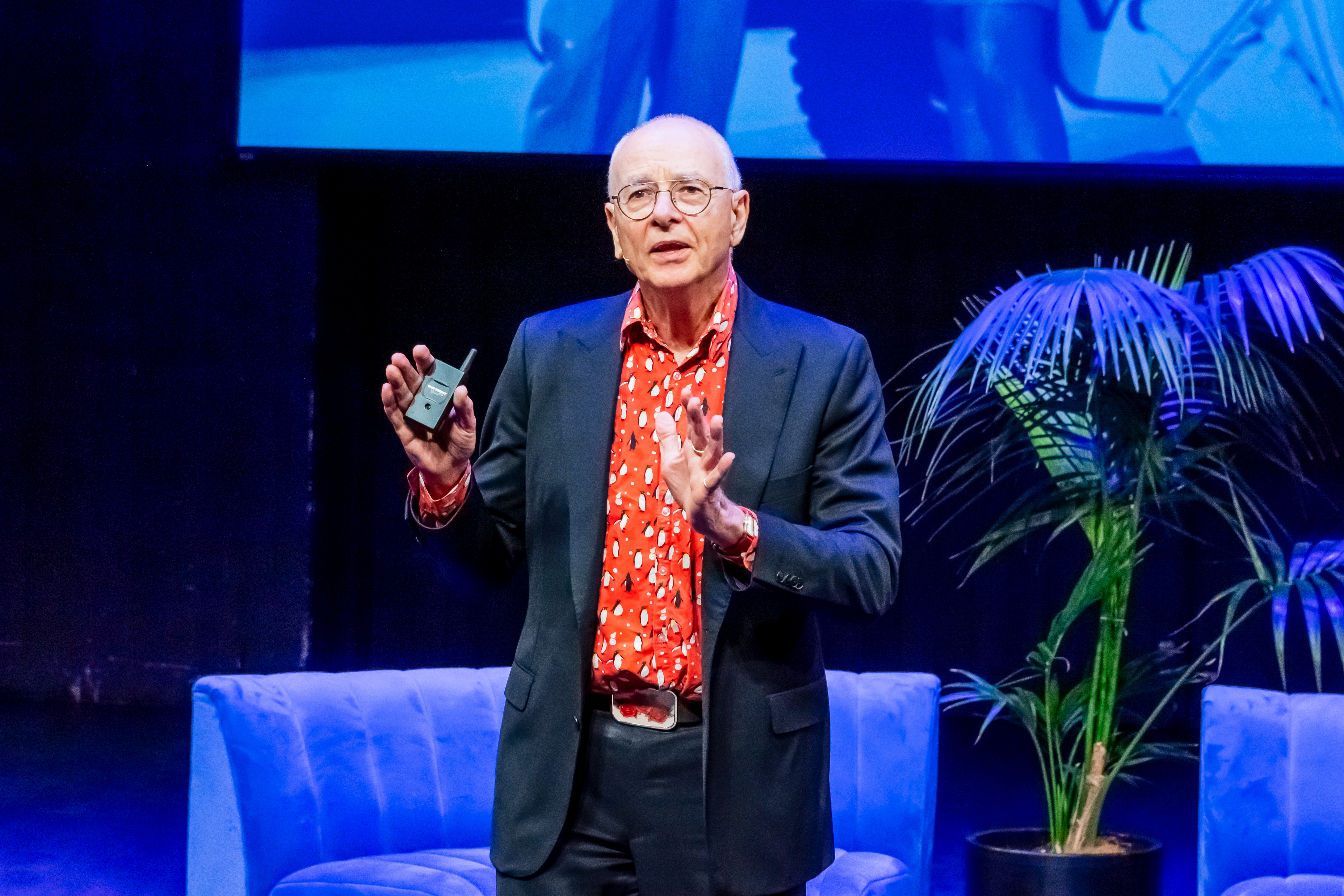 Man on stage speaking.