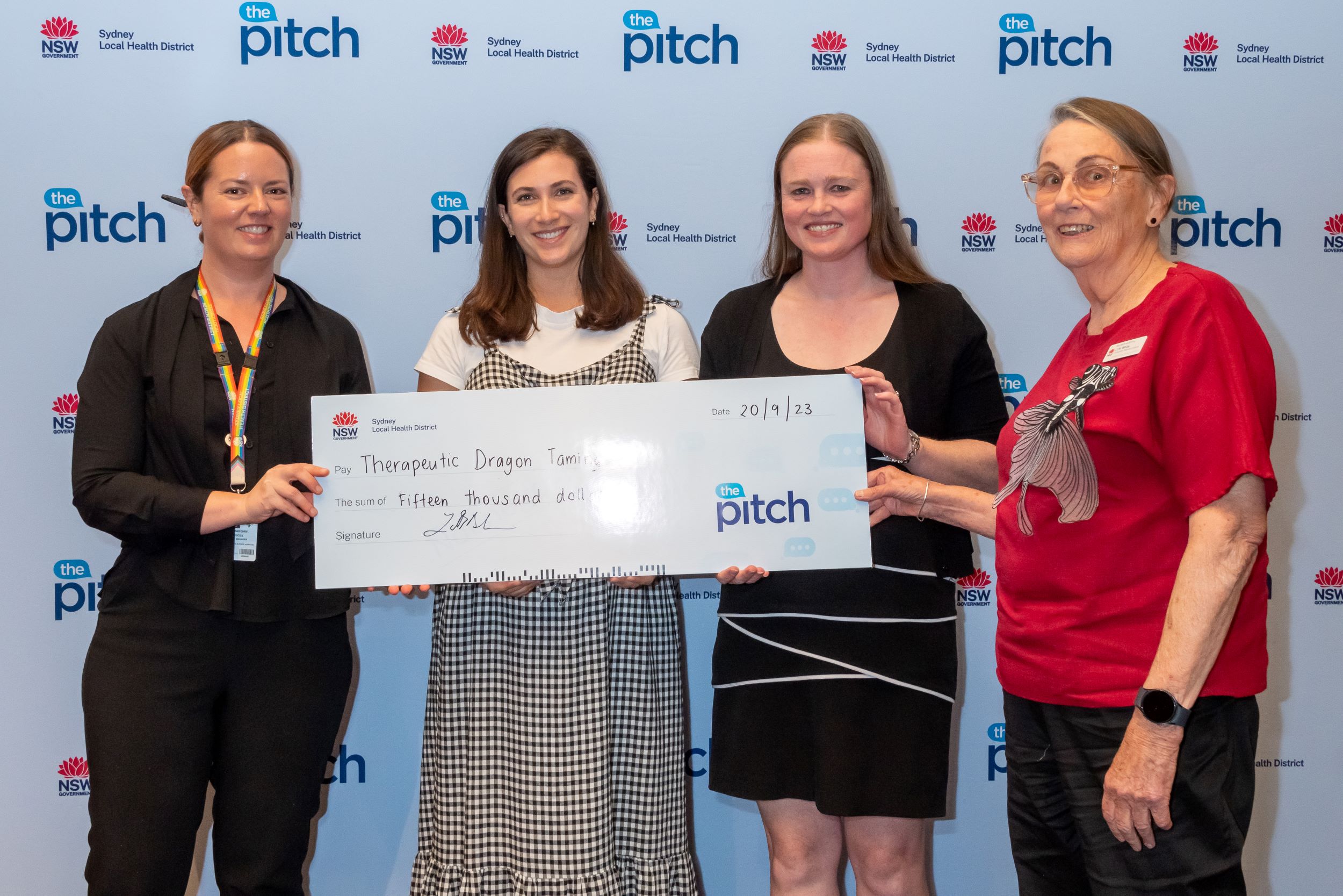 Four women holding a giant cheque