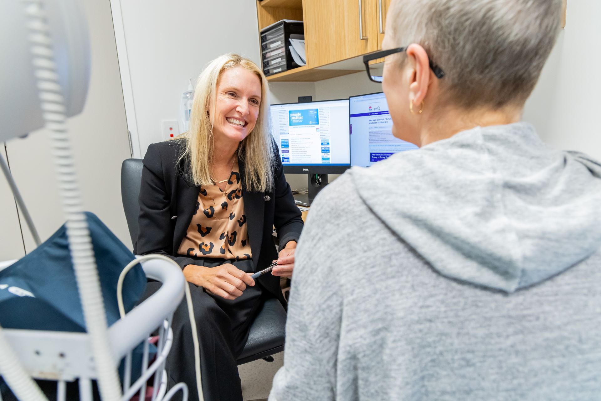 A clinician in a consult with a patient