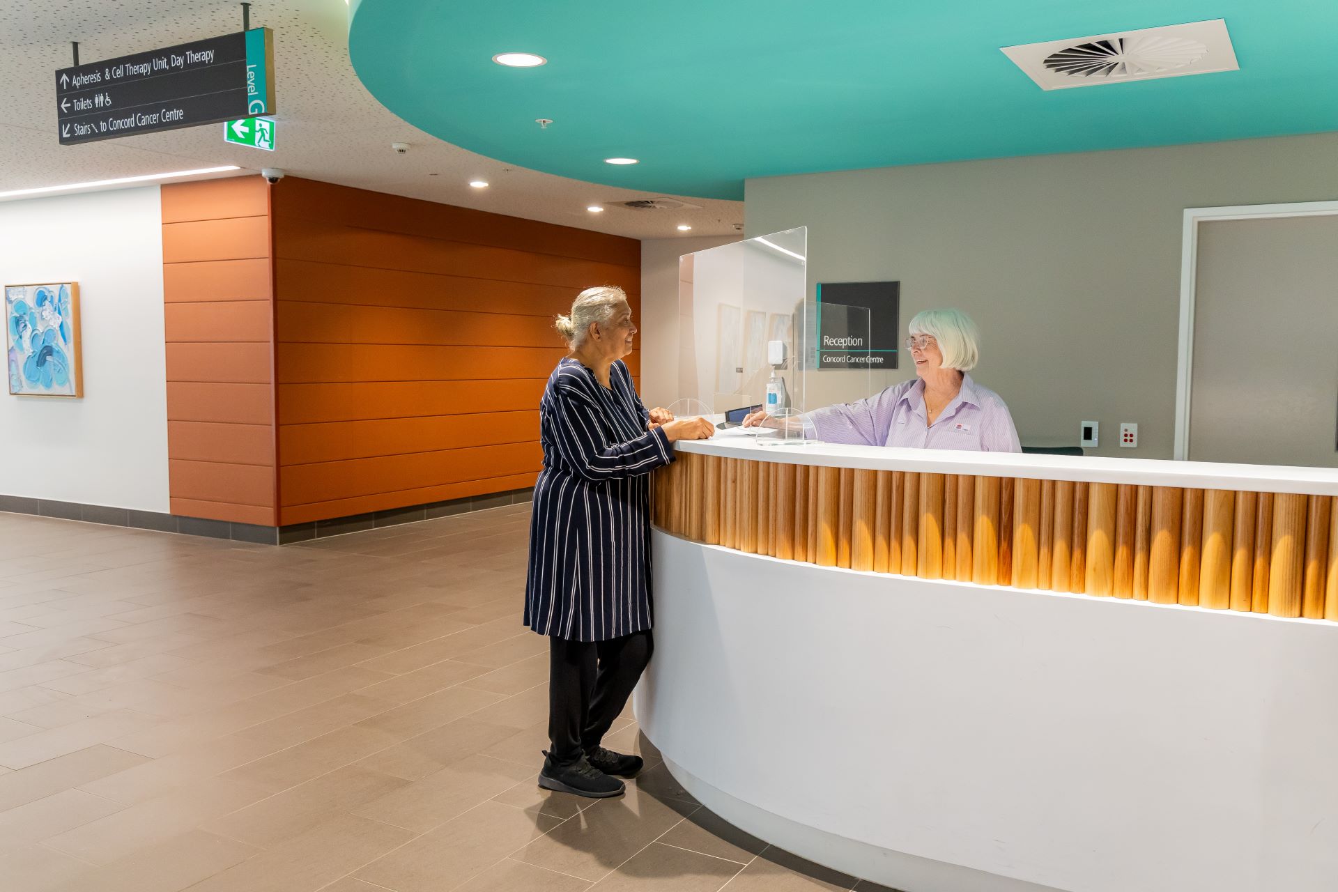  a person standing at a reception desk