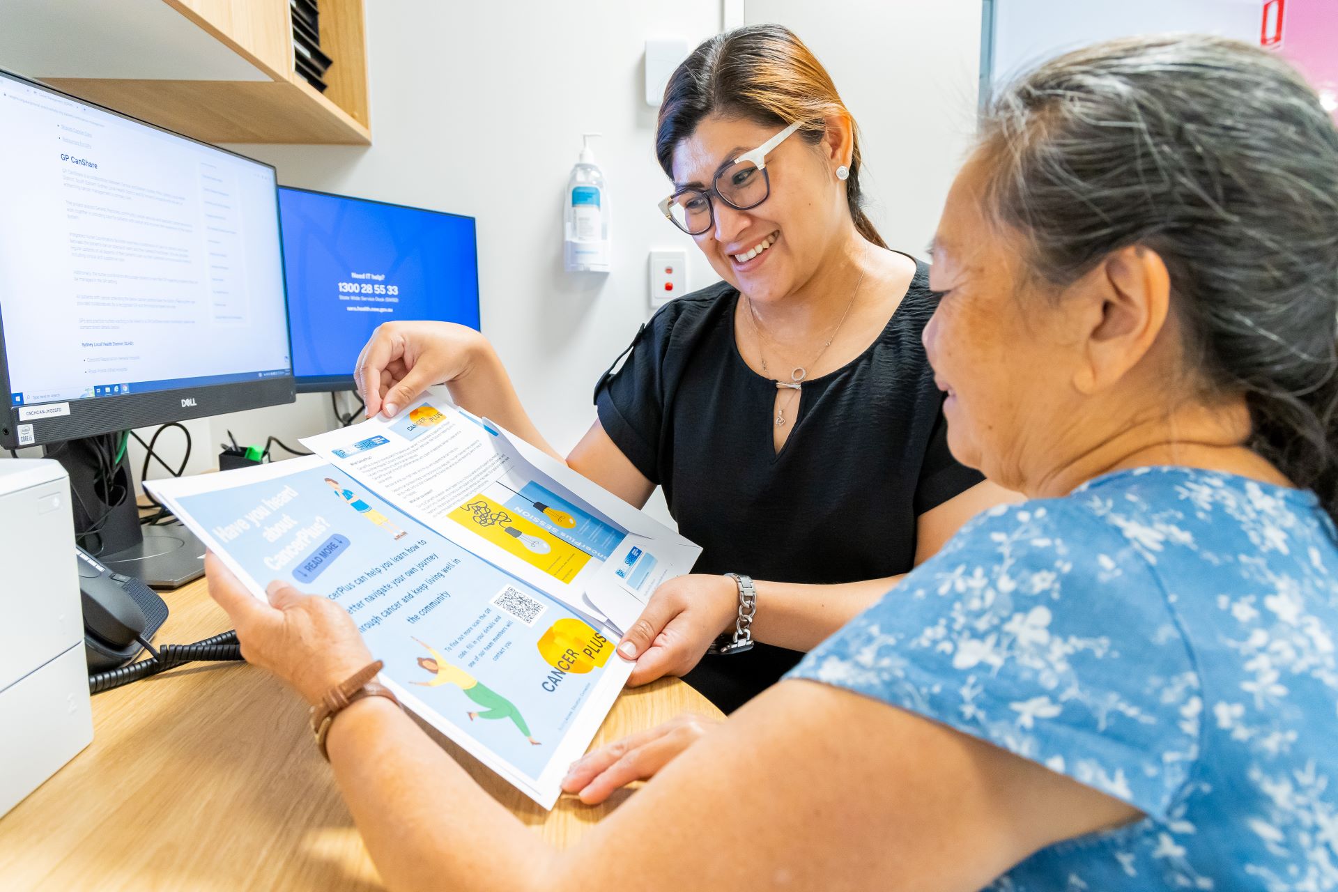 A person showing some paperwork to a patient