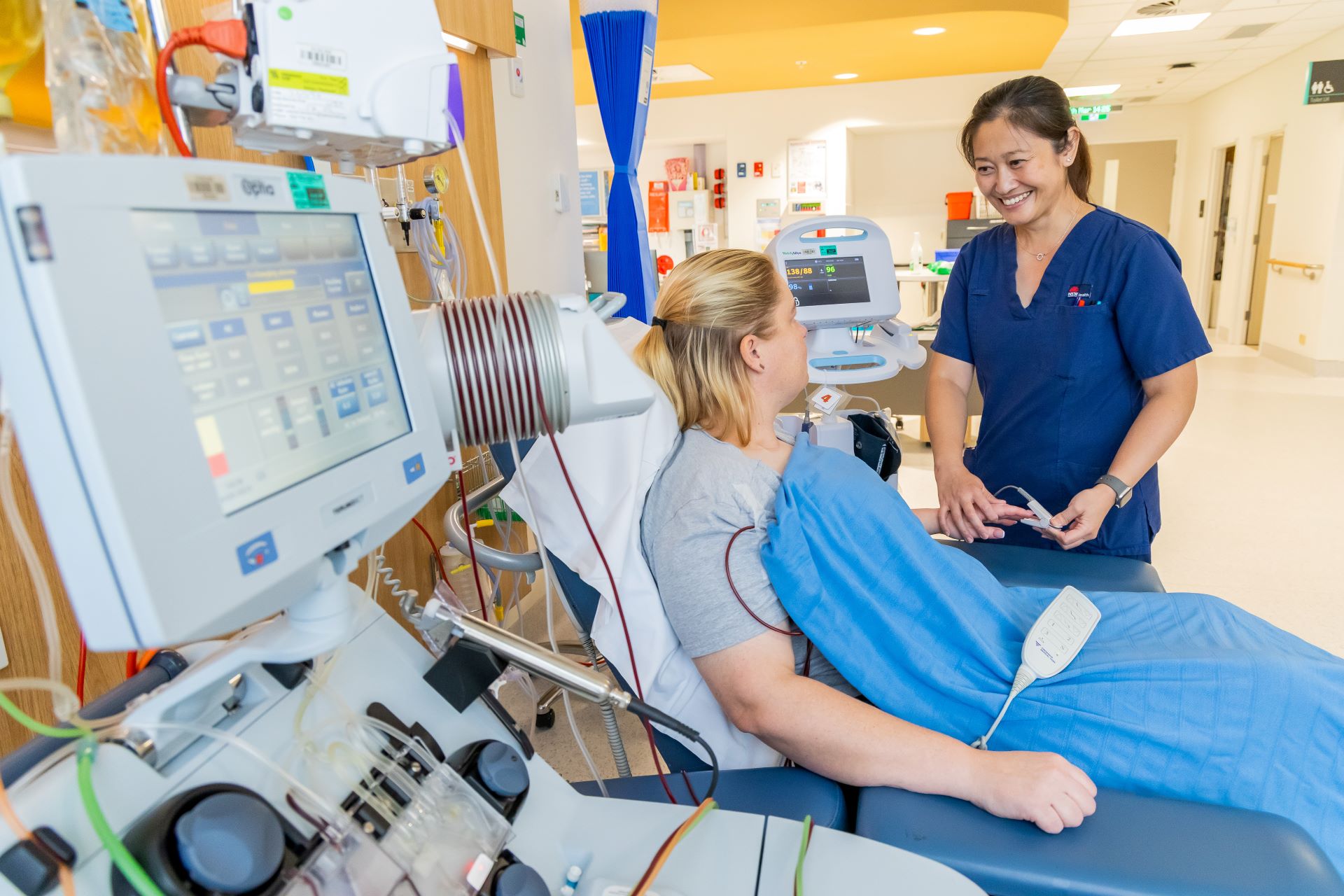 A nurse with a patient in a hospital bed