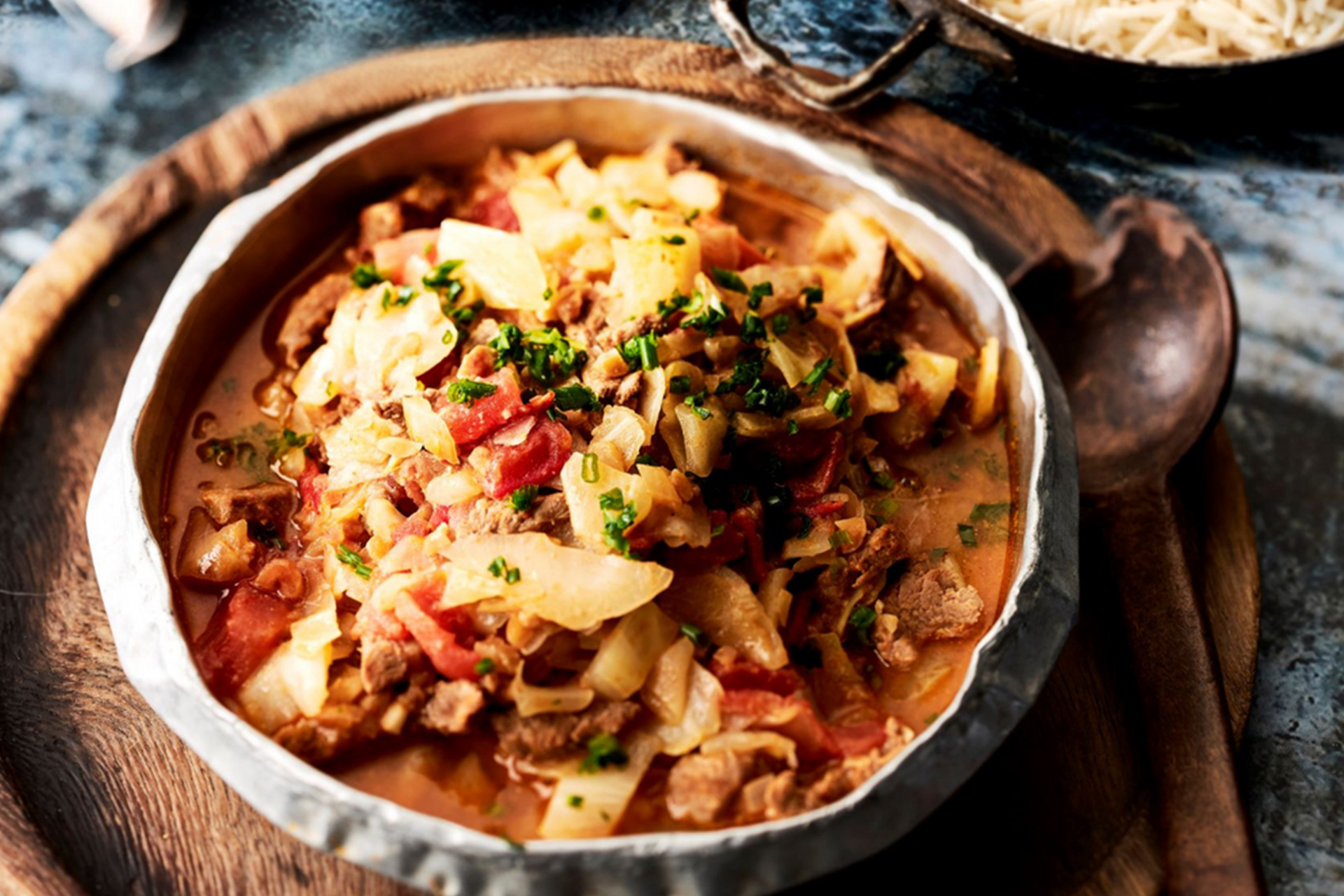 Congolese stew served in white bowl on brown wood dish