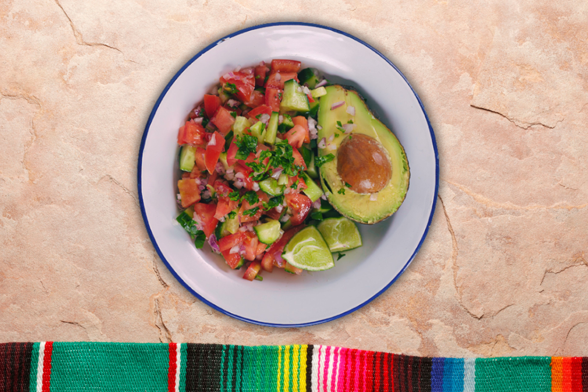 Salsa served in a bowl with half an avocado