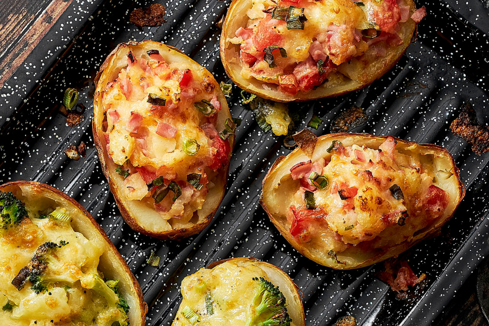 Stuffed potatoes in black speckled baking dish