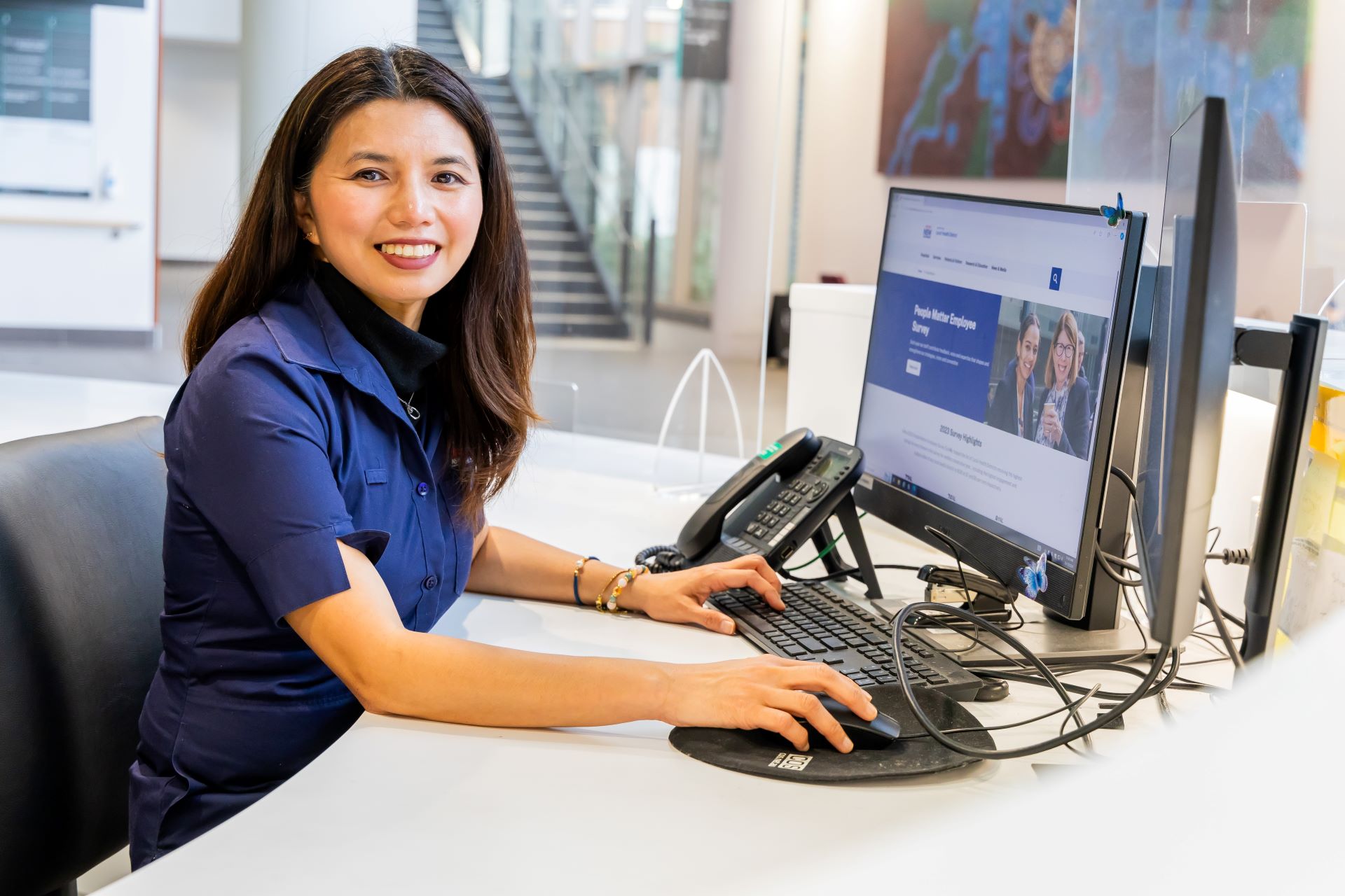 Staff member in front of computer workstation