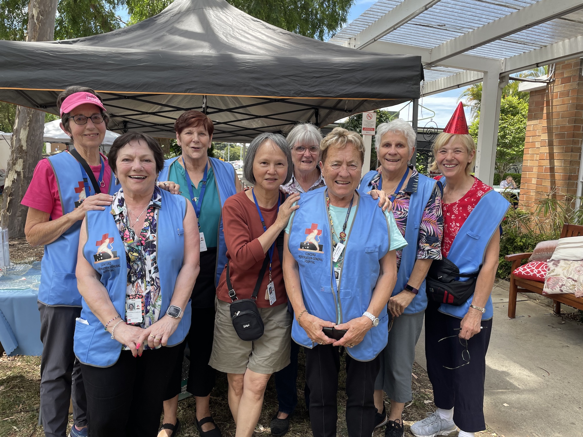 group of 8 volunteers pose for photo