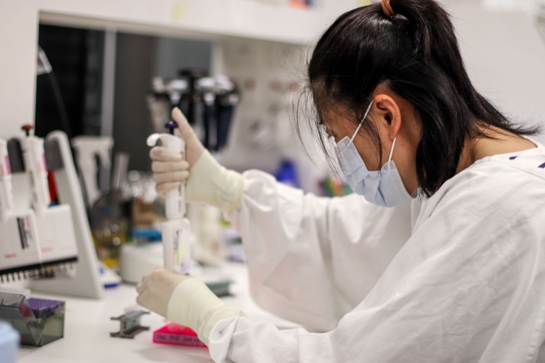 Scientist in a lab using pipette
