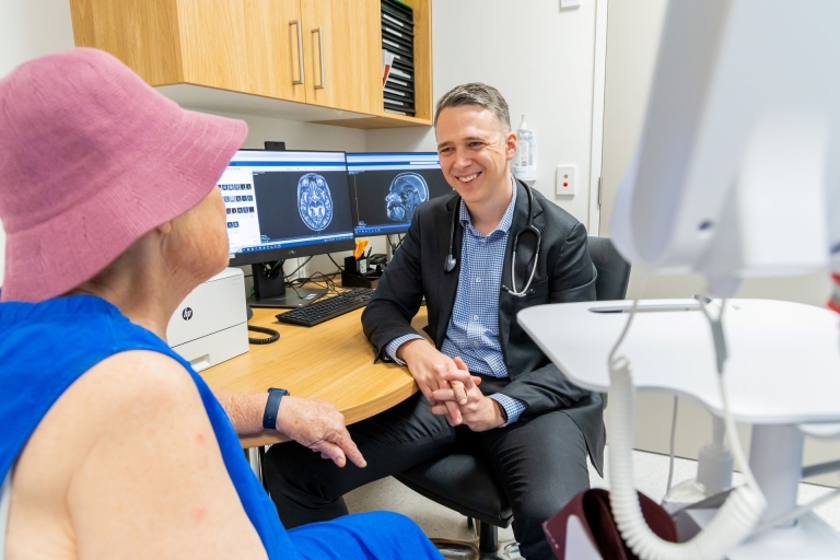 A doctor speaking to a patient at a consultation