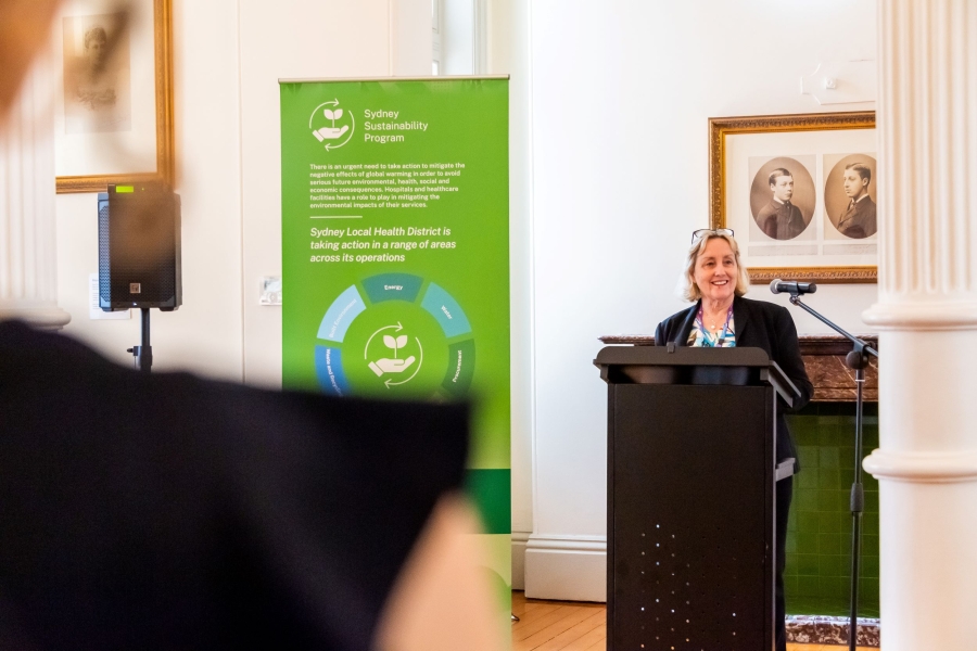 Woman standing behind podium talking