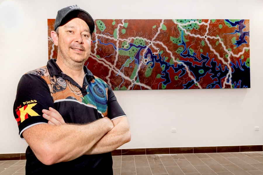 Artist Lee Hampton with artwork on display at Concord Hospital