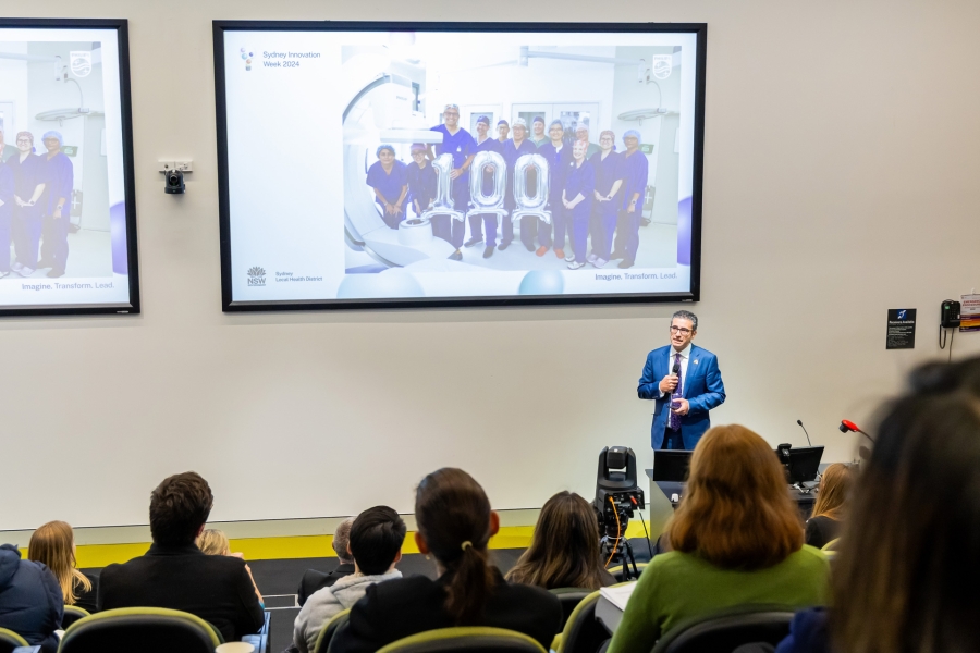Professor Tajalli Saghaie presenting in auditorium at Concord Hospital