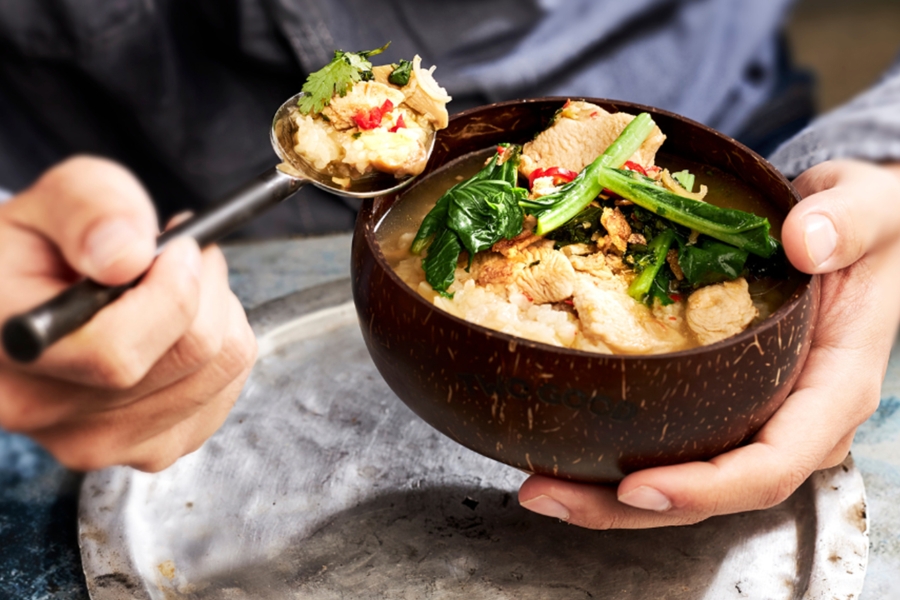 Hands holding bowl of food