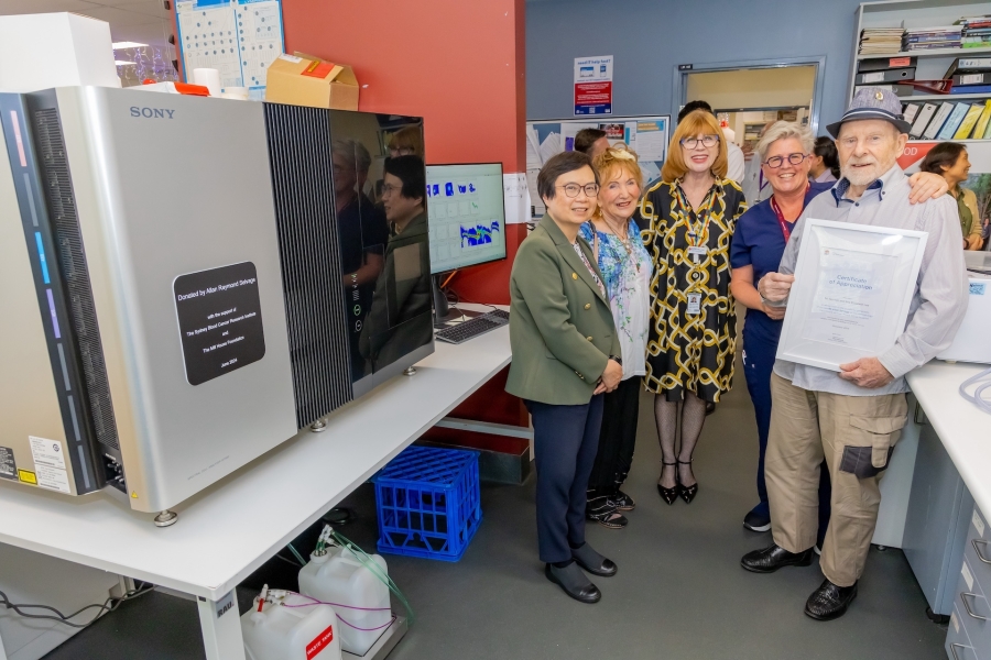 Photo of Spectral Cytometer next to five people posing for photo