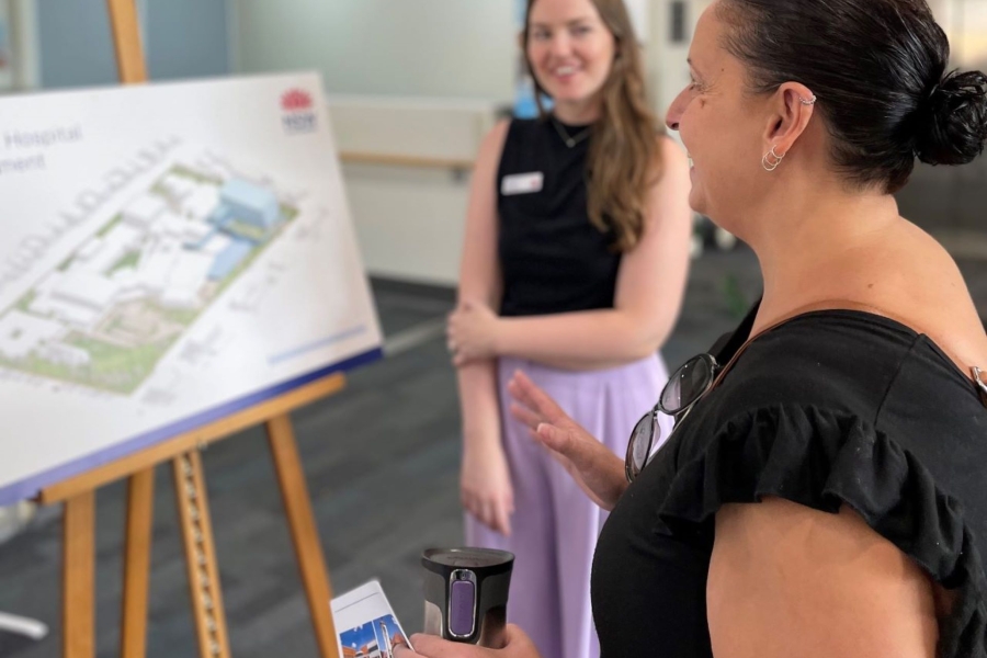 Two women talking about architectural plans