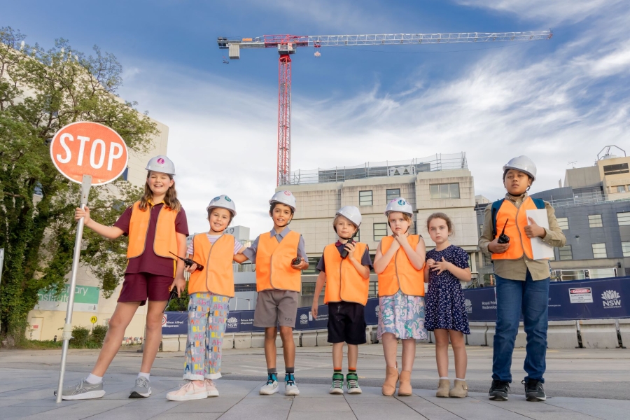 Children in construction safety clothing.